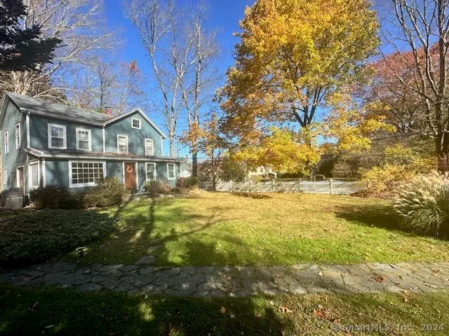 a view of residential houses with yard and swimming pool