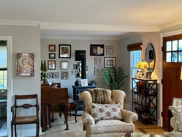 a living room with furniture a rug and a window
