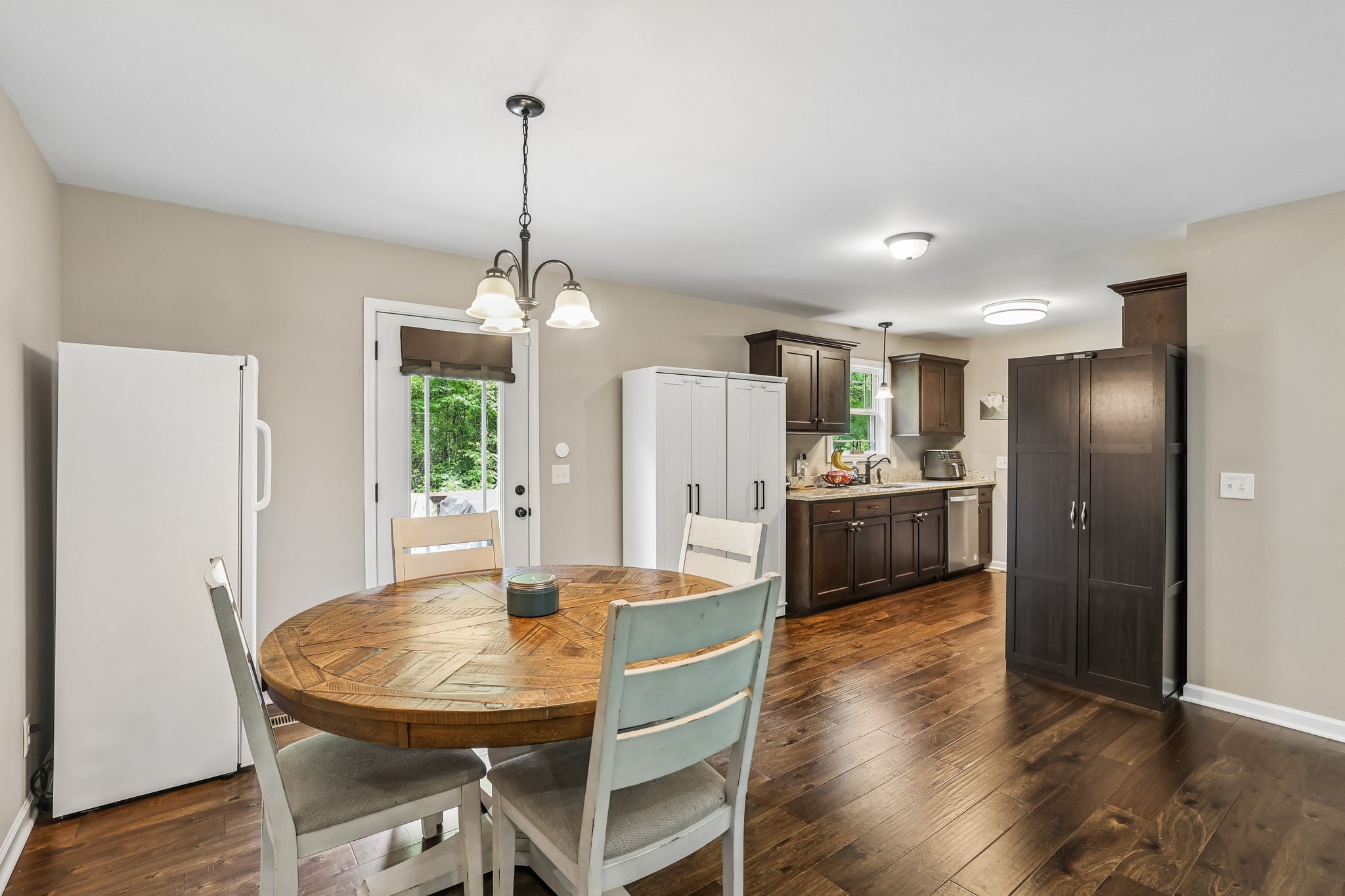 1546 South Spring Street Manchester, TN 37355 - Photo 18 of 53 a kitchen with stainless steel appliances a dining table chairs and wooden floor