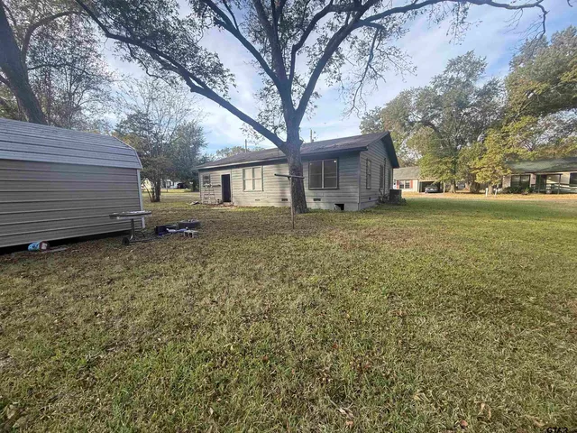 a view of a yard with tree s