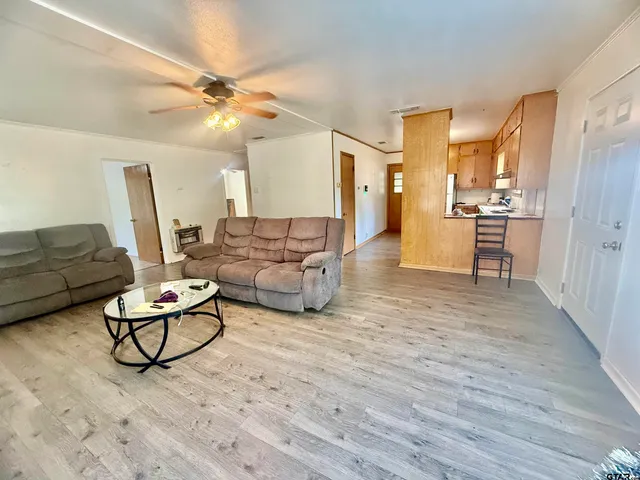 a living room with furniture window and wooden floor