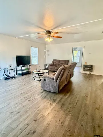a bedroom with a bed dresser and a window