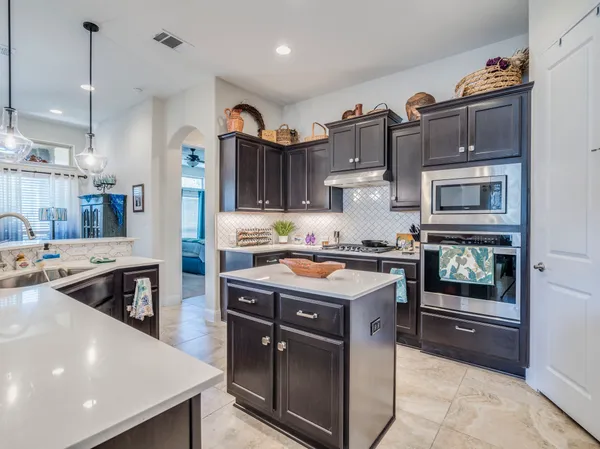 a kitchen with stainless steel appliances granite countertop a stove and a sink