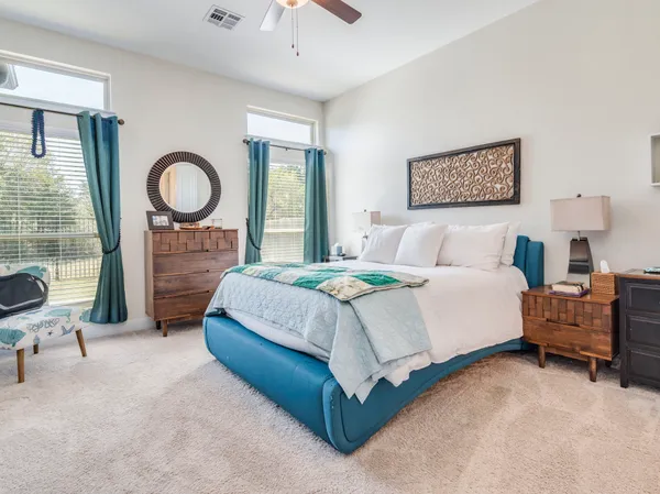 a bedroom with a bed and a chandelier