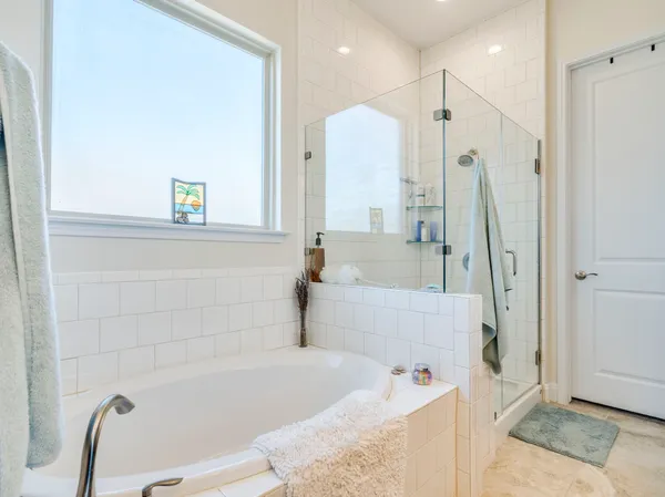 a bathroom with a tub a sink and a shower