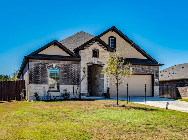 a front view of a house with a yard