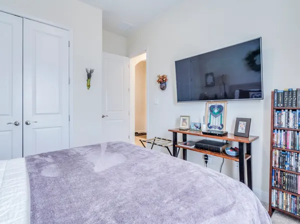 a bedroom with a bed and a book shelf