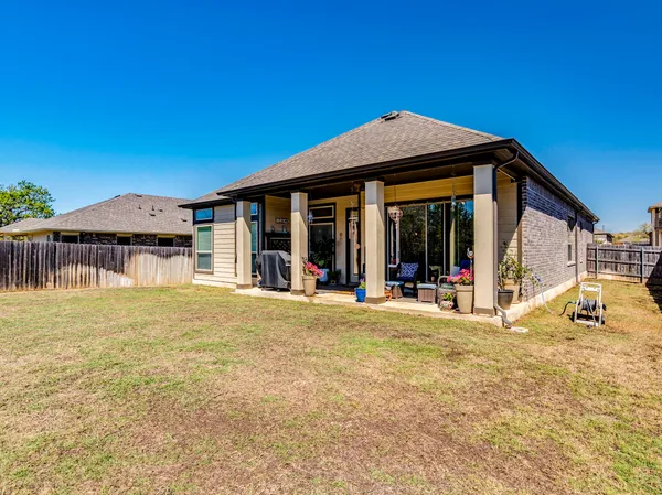 a view of a house with pool and sitting area