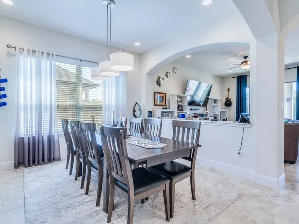 a kitchen with stainless steel appliances granite countertop a sink a stove and a wooden floors