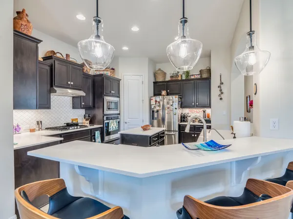 a kitchen with sink and refrigerator