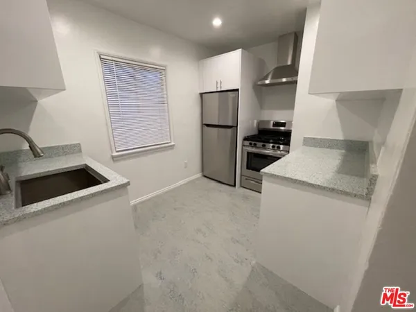 a kitchen with a refrigerator sink and stove