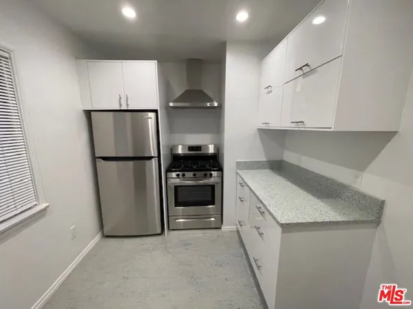 a kitchen with a sink a refrigerator and a stove