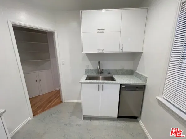 a kitchen with a sink and cabinets