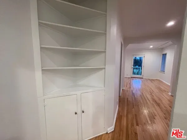 a view of a hallway view with wooden floor and staircase