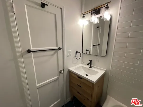 a bathroom with a sink and mirror