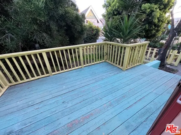 a view of deck with a large trees