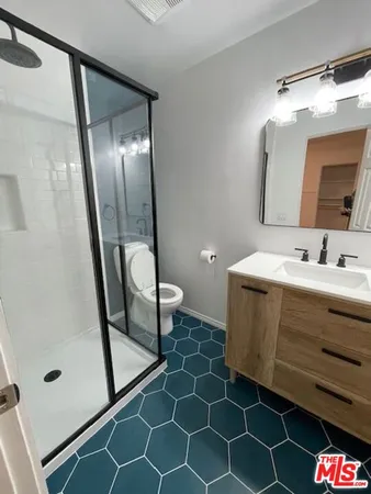 a bathroom with a sink mirror vanity and toilet