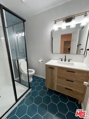 a bathroom with a sink mirror vanity and toilet