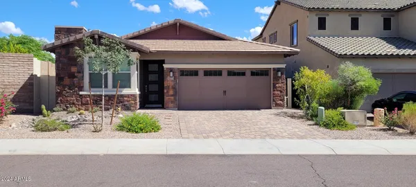 a front view of a house with a yard and a garage