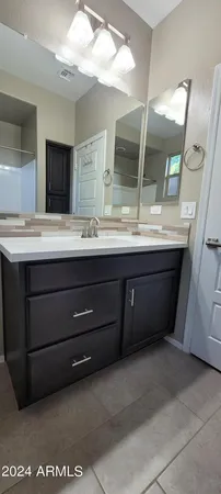 a bathroom with a double vanity sink and a mirror