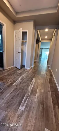 a view of a hallway with wooden floor