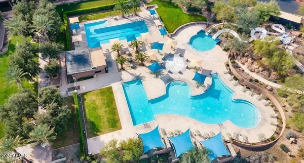 an aerial view of a house with a yard and swimming pool