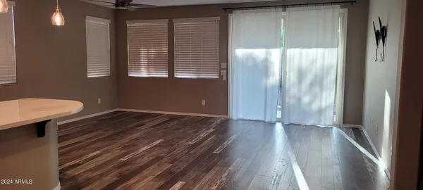 a view of a room with wooden floor and a window