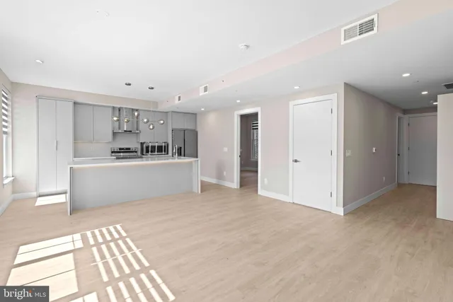 a view of a kitchen with a sink and a refrigerator cabinets