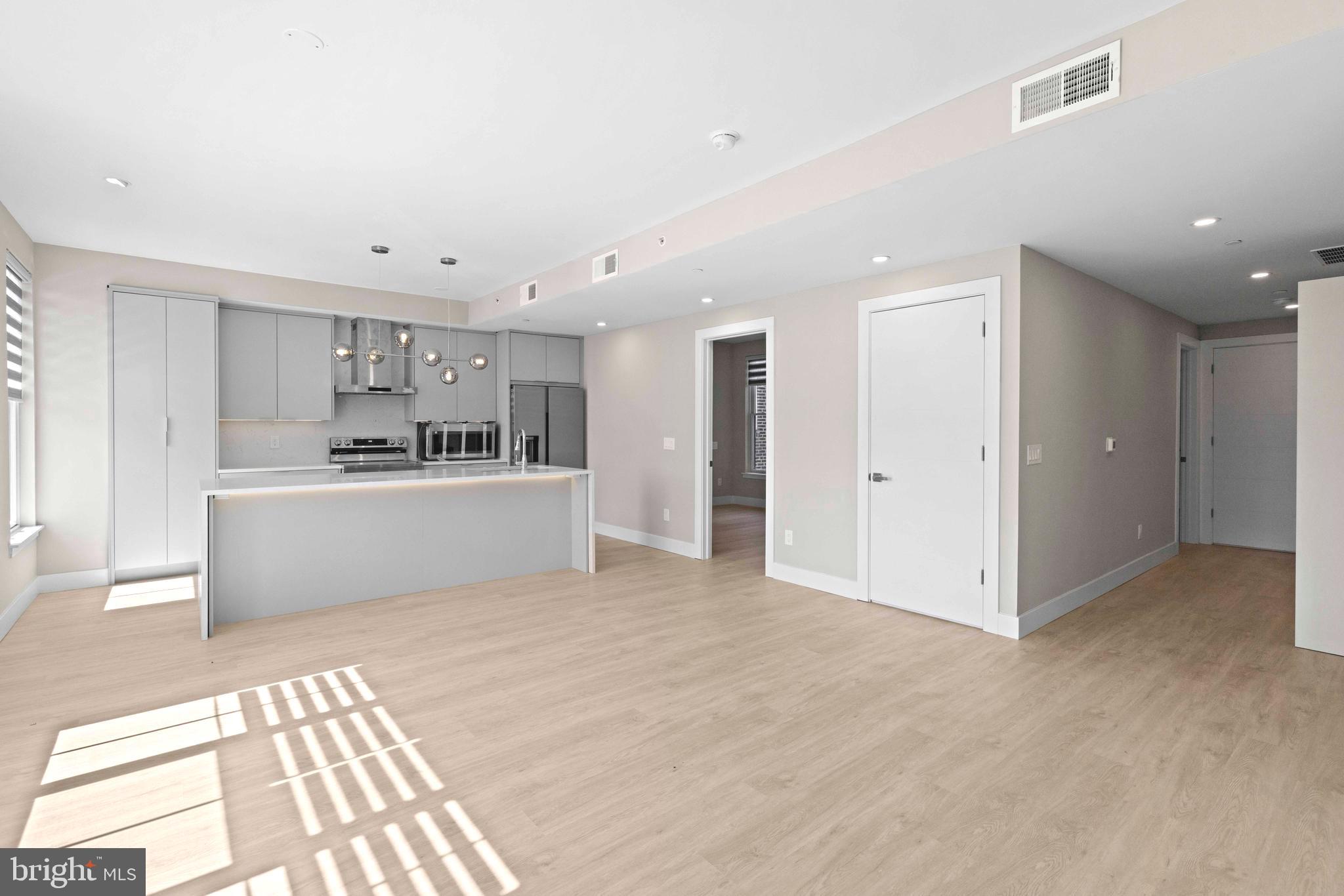 a view of a kitchen with a sink and a refrigerator cabinets