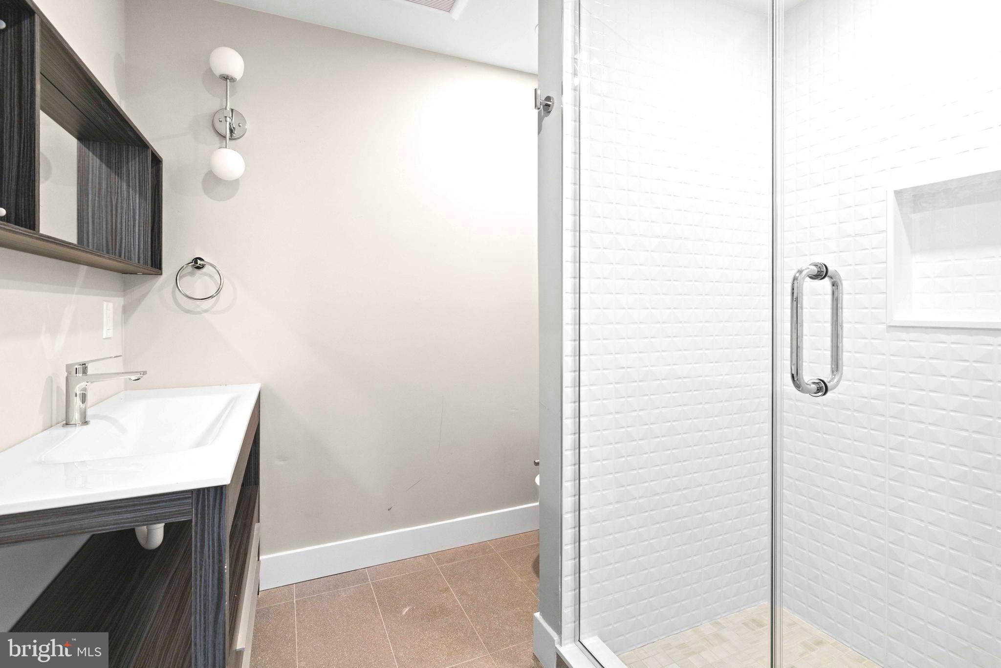 4720 Richmond Street, Unit 1 Philadelphia, PA 19137 - Photo 14 of 14 a bathroom with a sink and a mirror