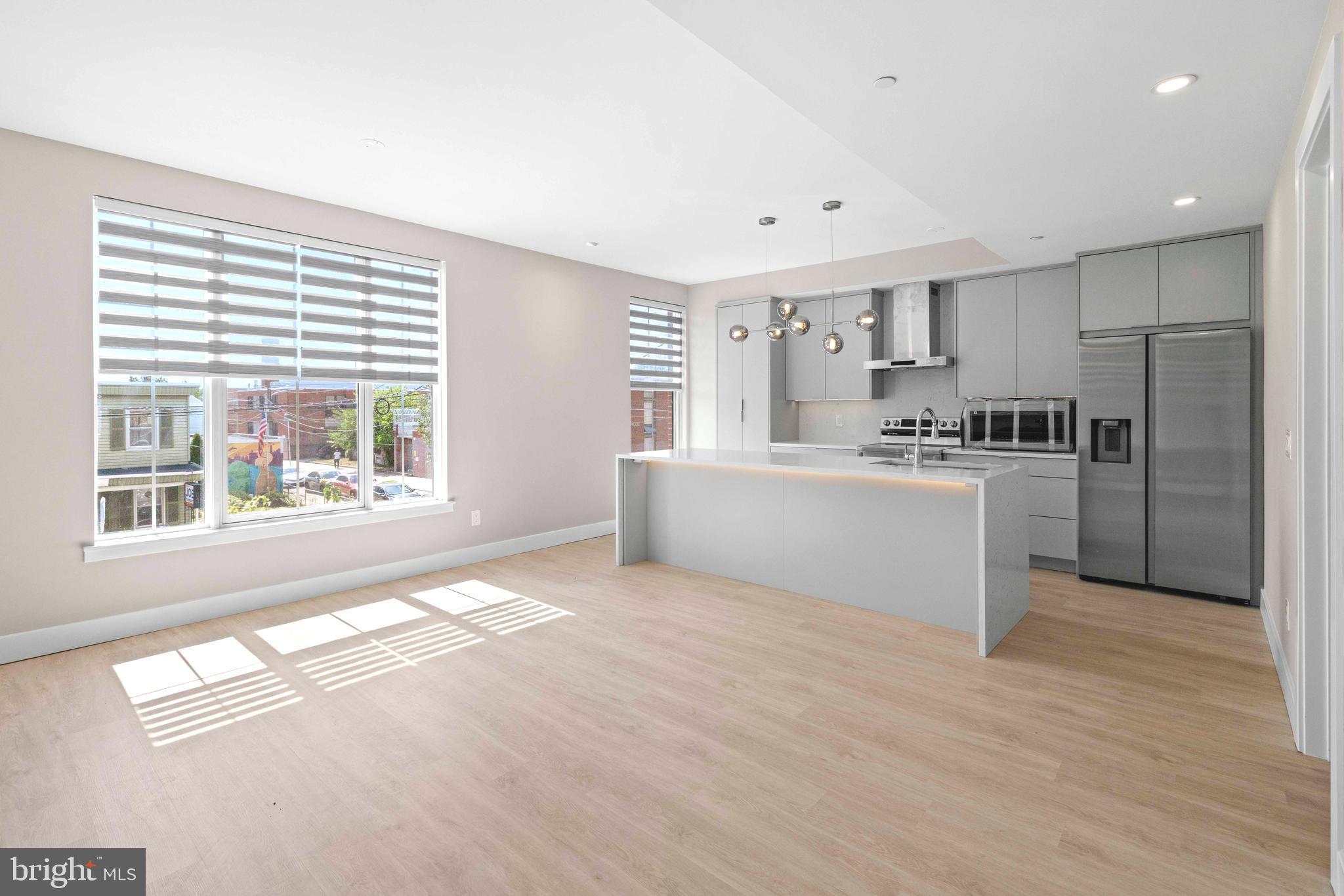 4720 Richmond Street, Unit 1 Philadelphia, PA 19137 - Photo 2 of 14 a large white kitchen with a large window