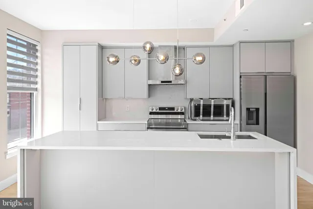 a kitchen with stainless steel appliances a refrigerator and a stove
