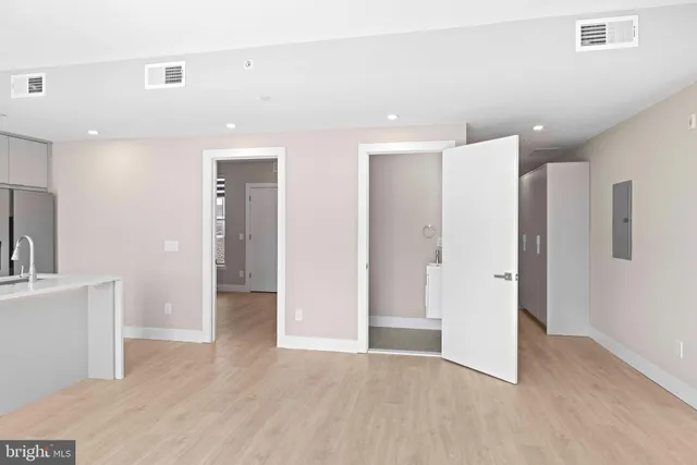 a view of a kitchen with a sink and a refrigerator