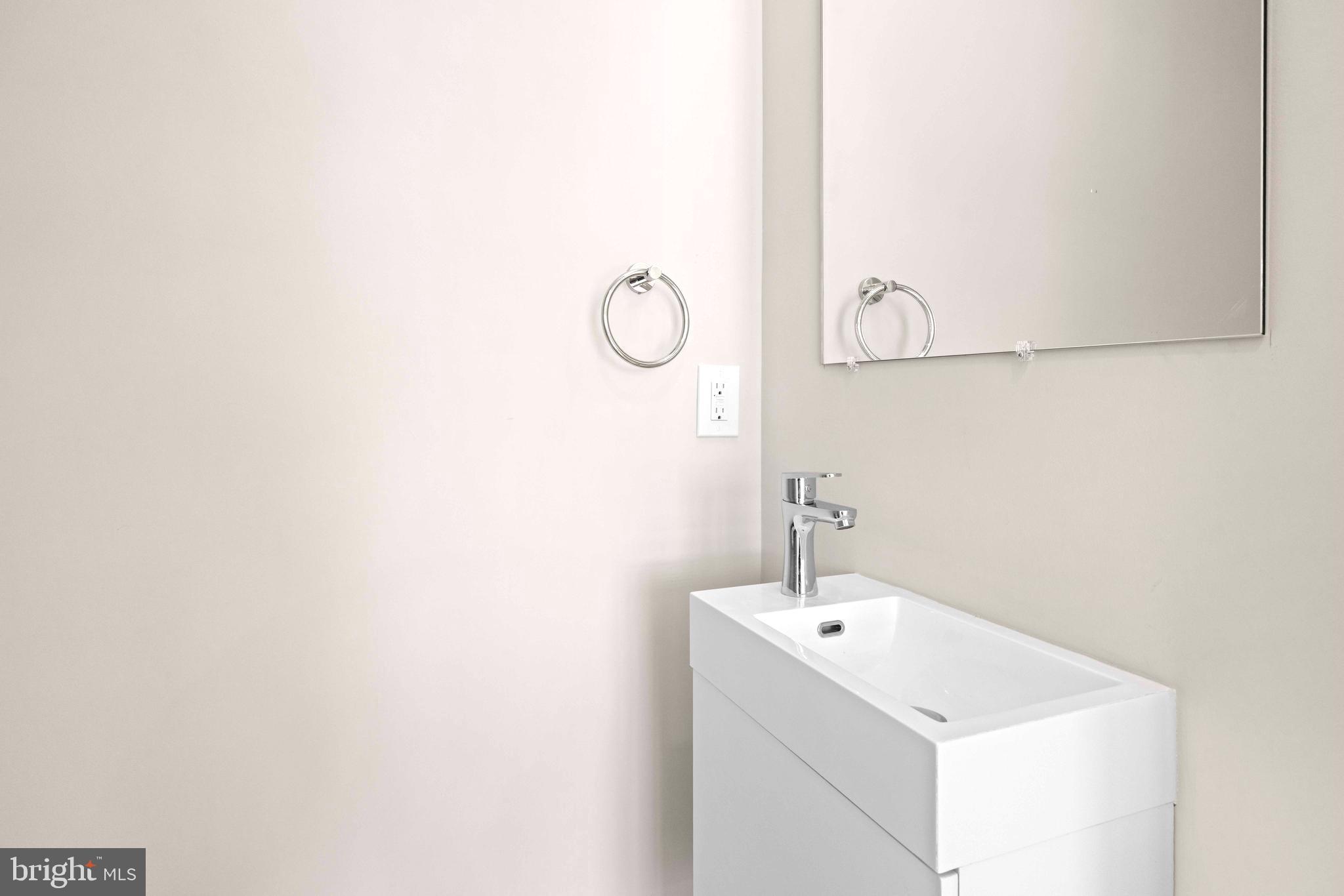 4720 Richmond Street, Unit 1 Philadelphia, PA 19137 - Photo 7 of 14 a bathroom with a sink and mirror