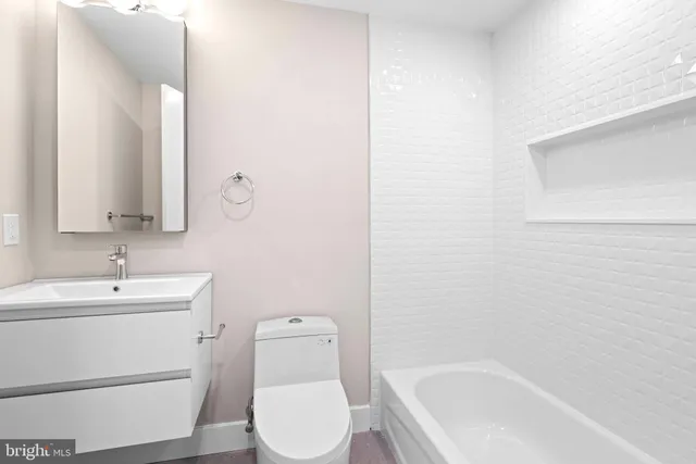 a bathroom with a sink a toilet and bathtub