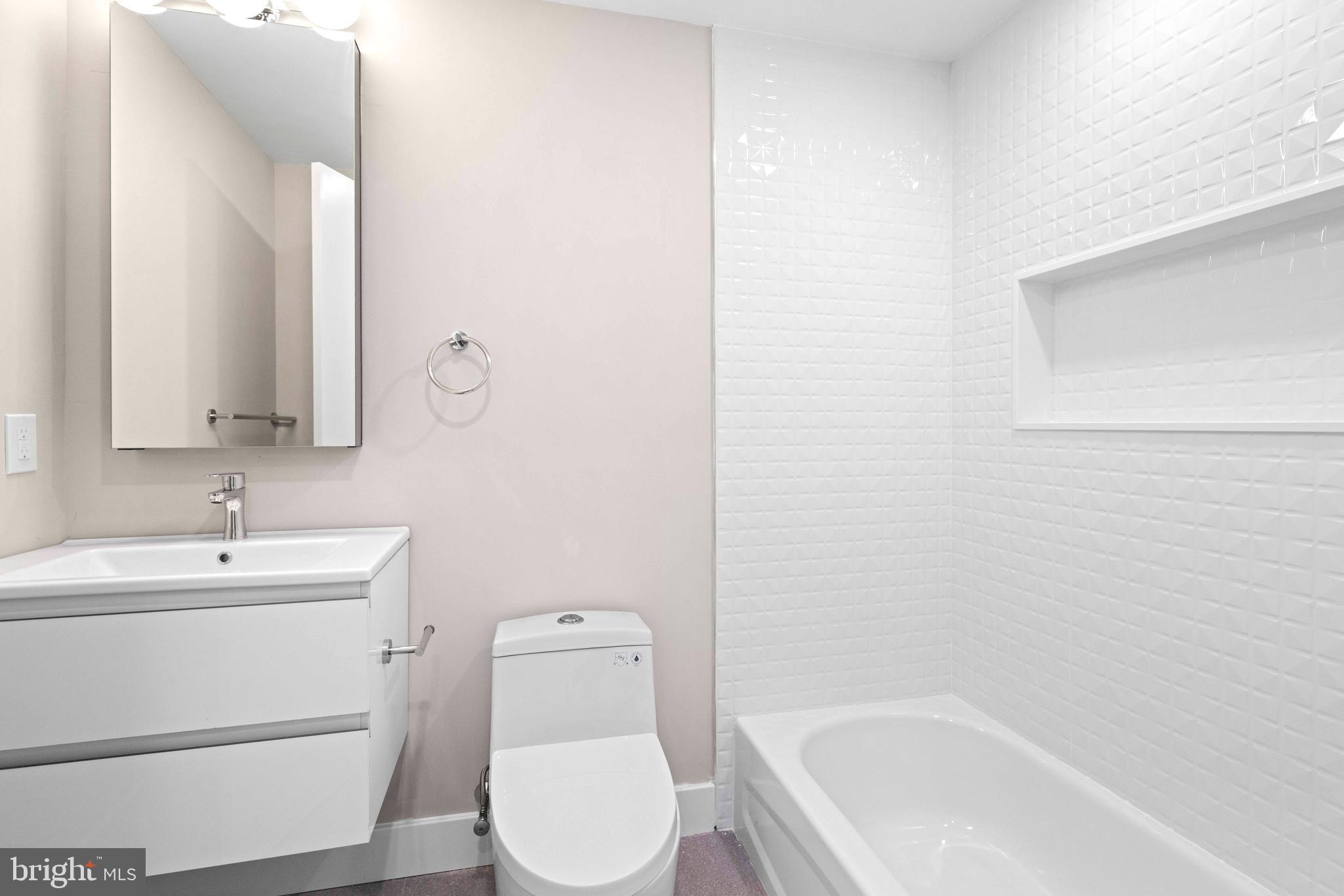 4720 Richmond Street, Unit 1 Philadelphia, PA 19137 - Photo 10 of 14 a bathroom with a sink a toilet and bathtub