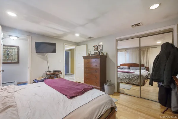 a bedroom with a bed and a mirror