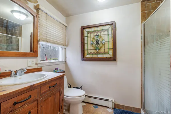 a bathroom with a sink mirror vanity and toilet