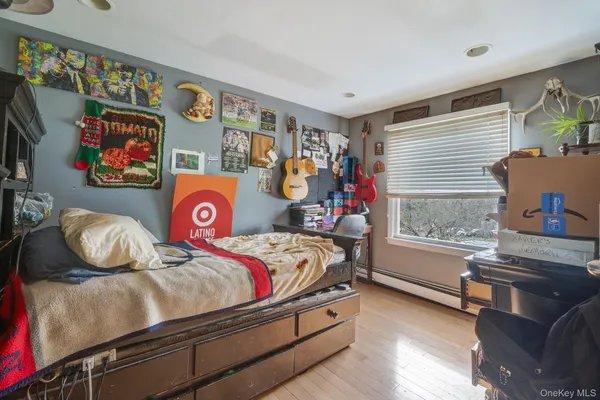 a bedroom with furniture and a window