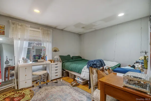 a bedroom with a bed and large windows