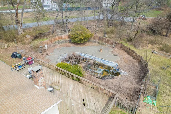 an aerial view of residential house with pool and yard