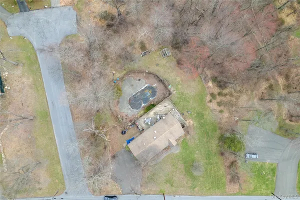 an aerial view of a house with yard swimming pool and outdoor seating