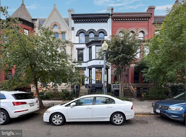 a view of a car parked in front of a house