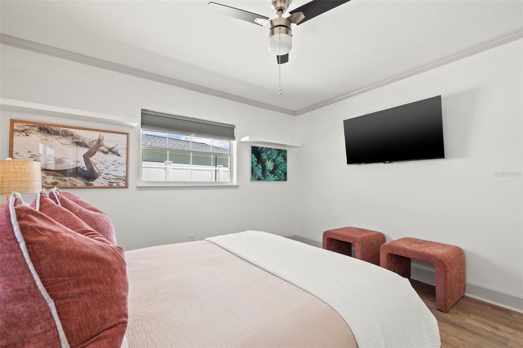 11225 2nd Street East, Unit A Treasure Island, FL 33706 - Photo 16 of 25 a bedroom with a bed and a flat screen tv