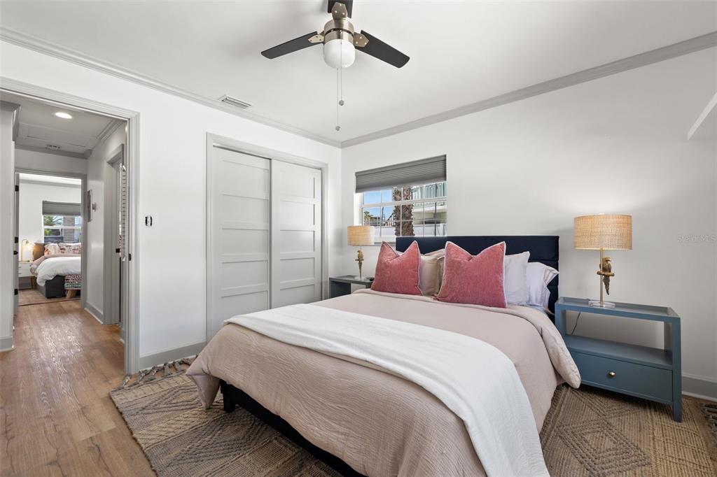 11225 2nd Street East, Unit A Treasure Island, FL 33706 - Photo 17 of 25 a bedroom with a bed and a chandelier