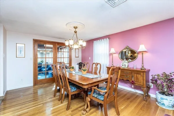 a view of a dining room with furniture and chandelier