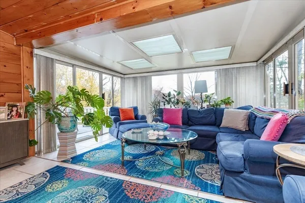 a living room with furniture potted plant and a window