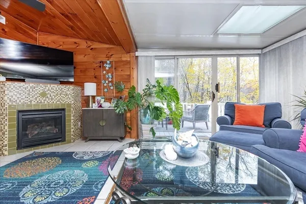 a living room with furniture a fireplace and a flat screen tv