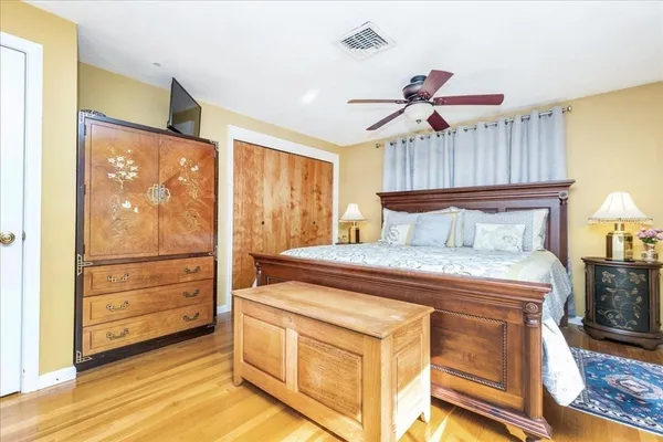 a bedroom with a bed and a cabinet