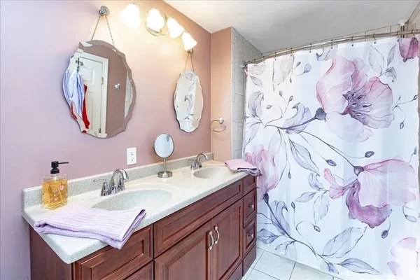 a bathroom with a sink vanity and a mirror